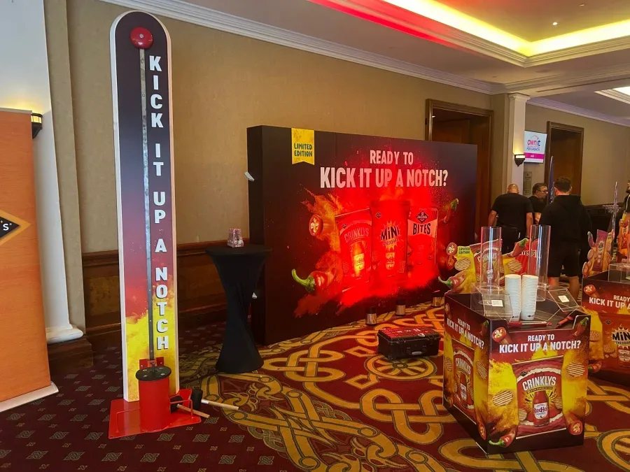Branded Kick it up a notch high striker at a hotel product launch